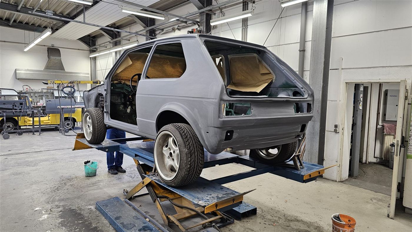 VW Golf I Karosserie grundiert auf der Hebebühne